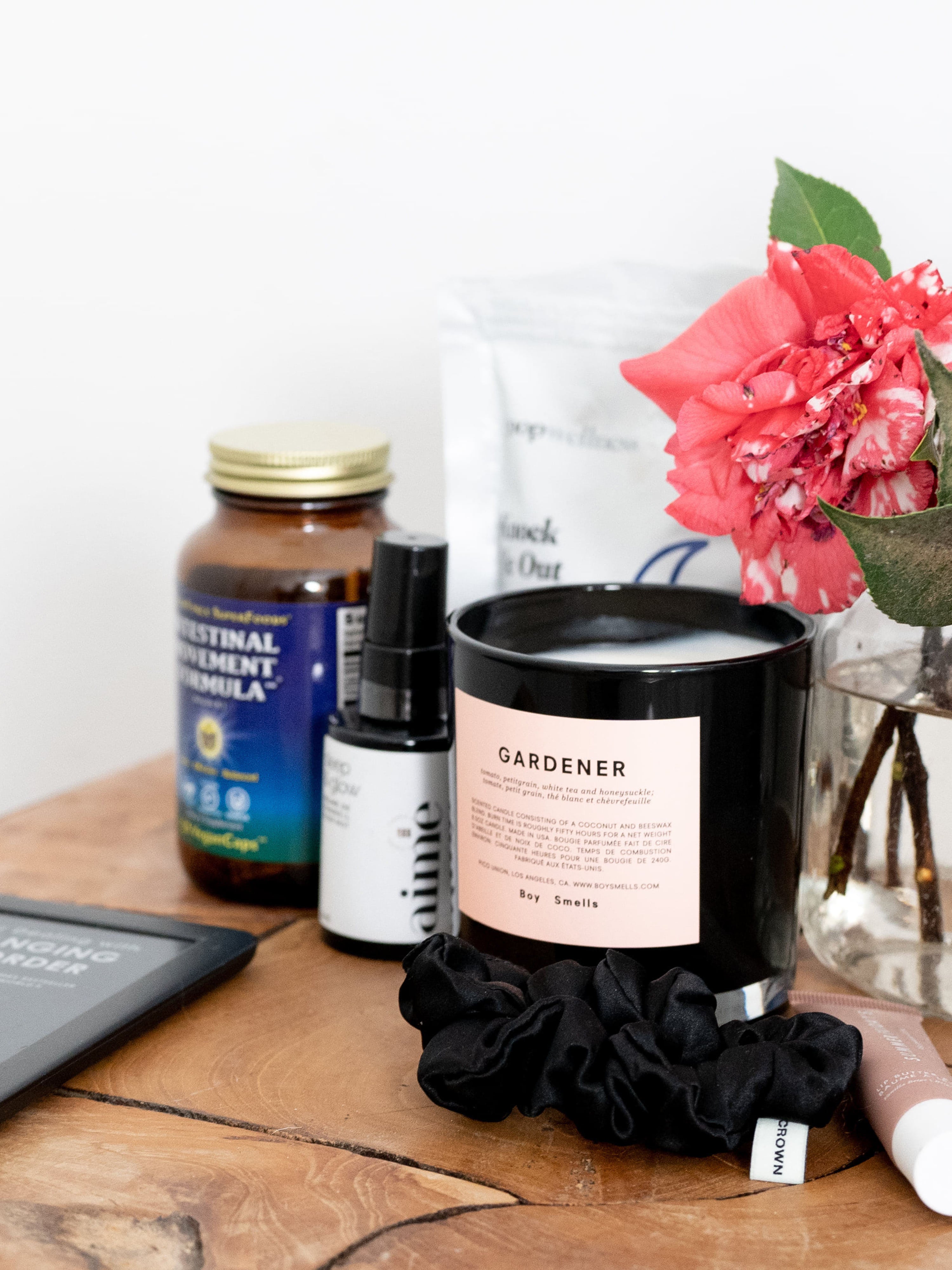 Allison Bornstein's nightstand with a candle, Kindle, and various products.