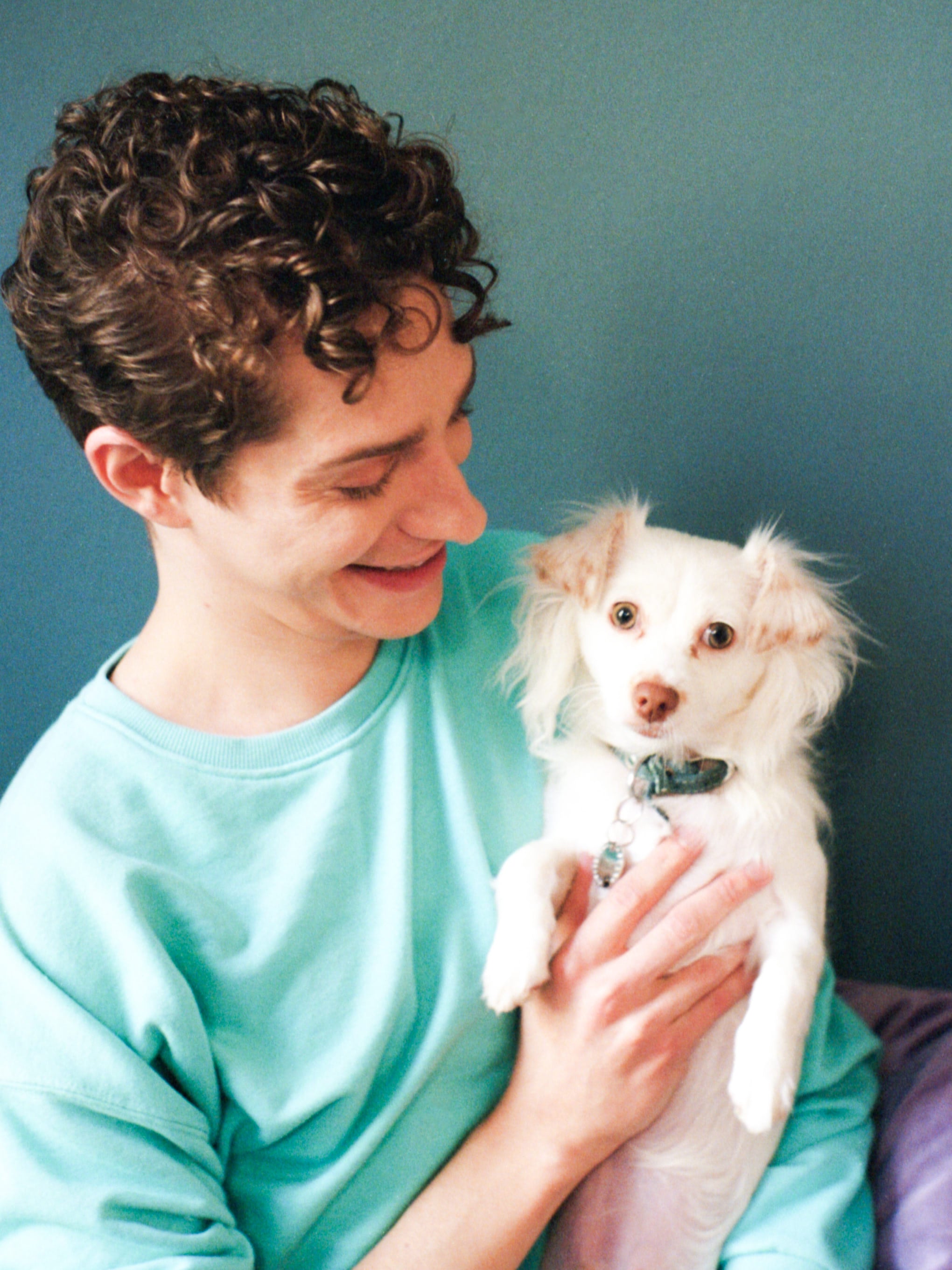 Actor Dino Petrera, holding his dog as he looks at him