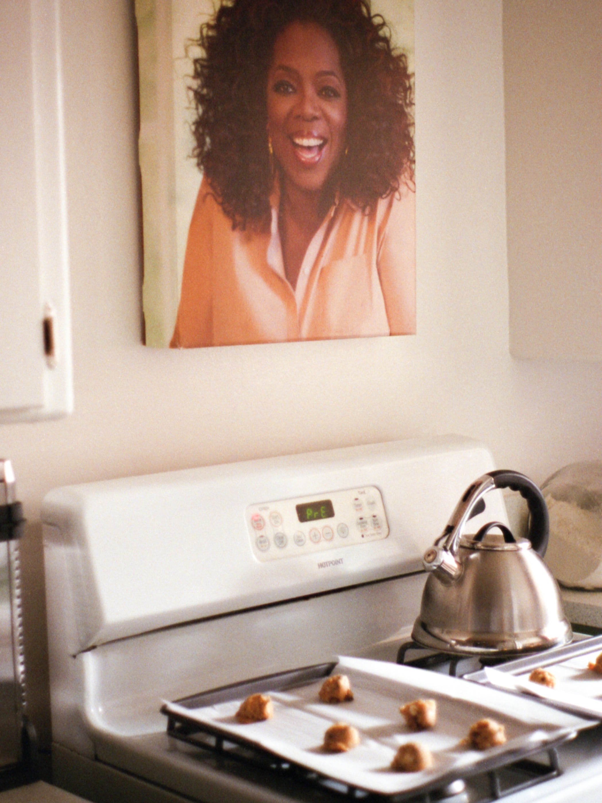 Dino Petrera's kitchen with a photo of Oprah and uncooked cookies on a sheet pan on his stove
