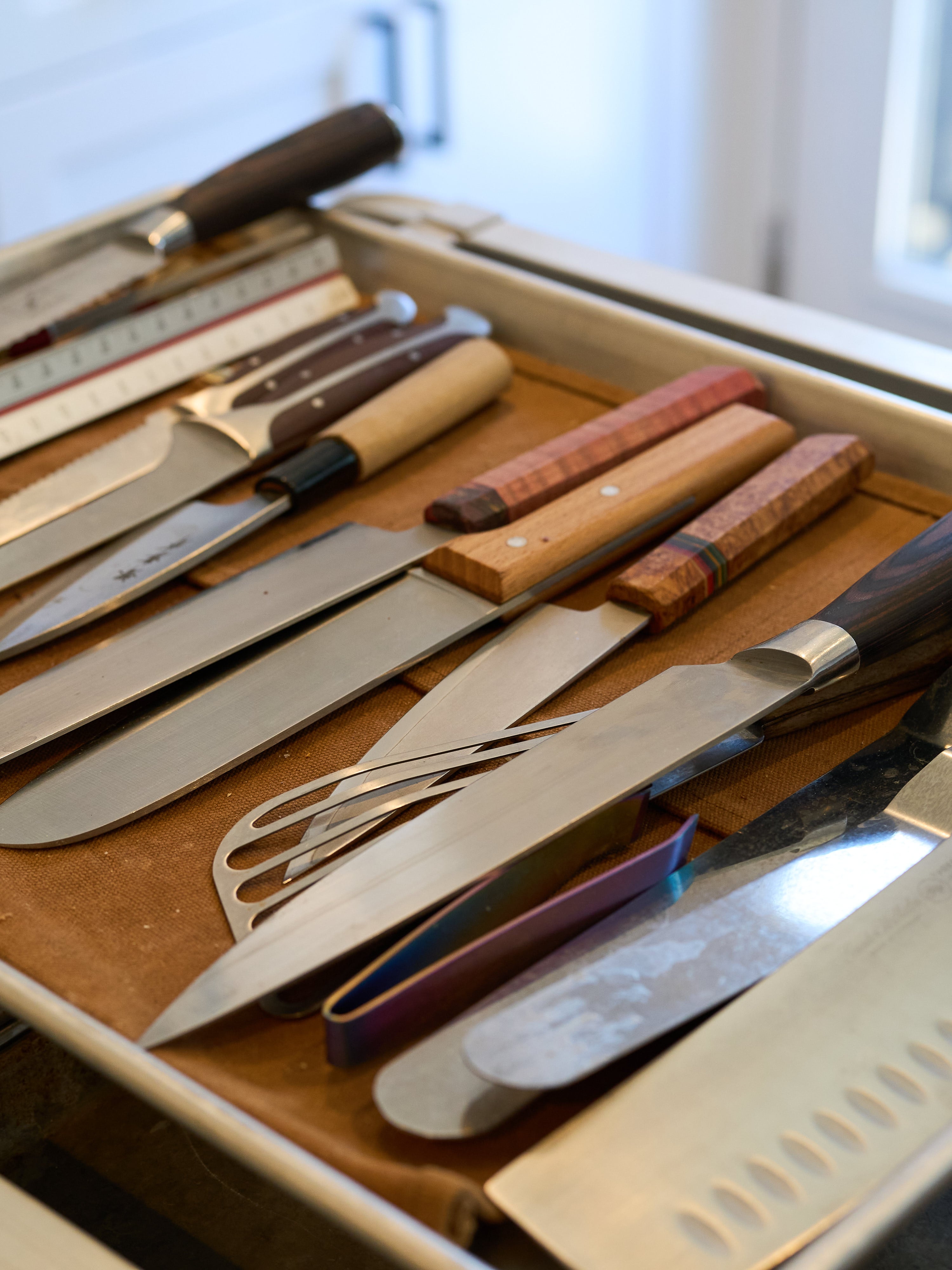 Chef Sandy Truong An Tran Ho's knives in a sheet pan