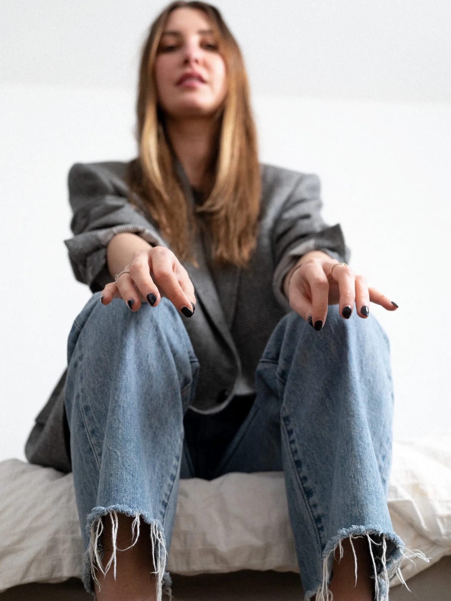 Allison Bornstein meditating, with her hands in focus and close to the camera.