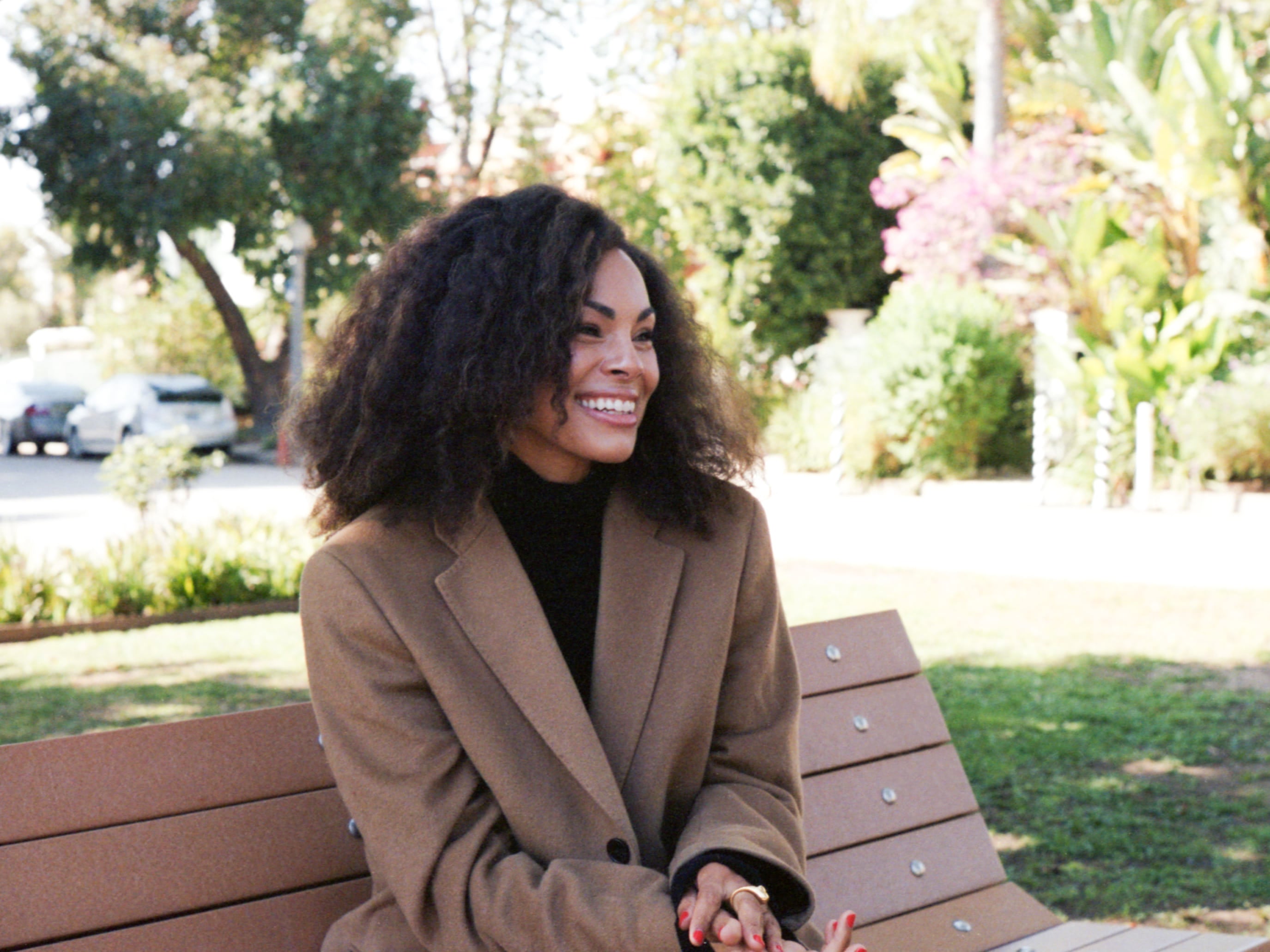 Maxine Goynes, founder and podcast host of MG Method, sitting on a park bench