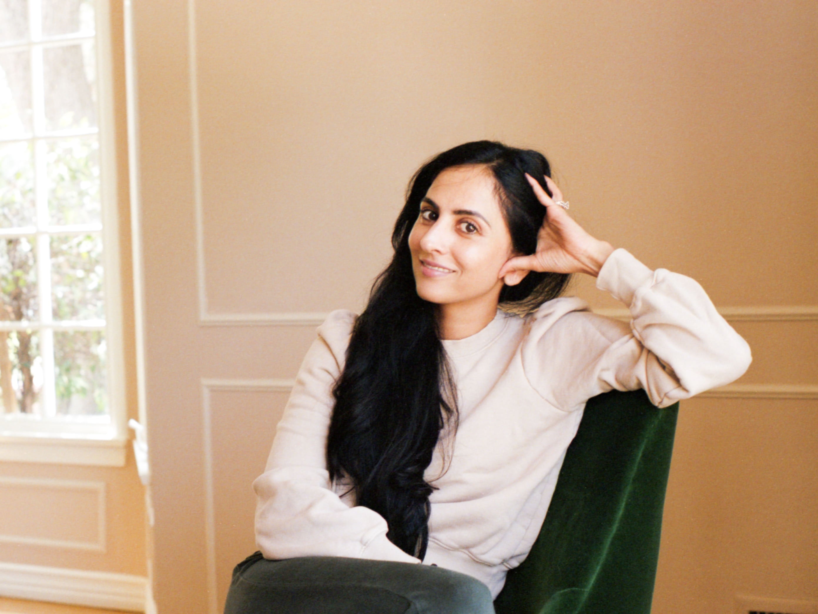 Michelle Ranavat, founder of Ranavat, sitting in her dining room smiling