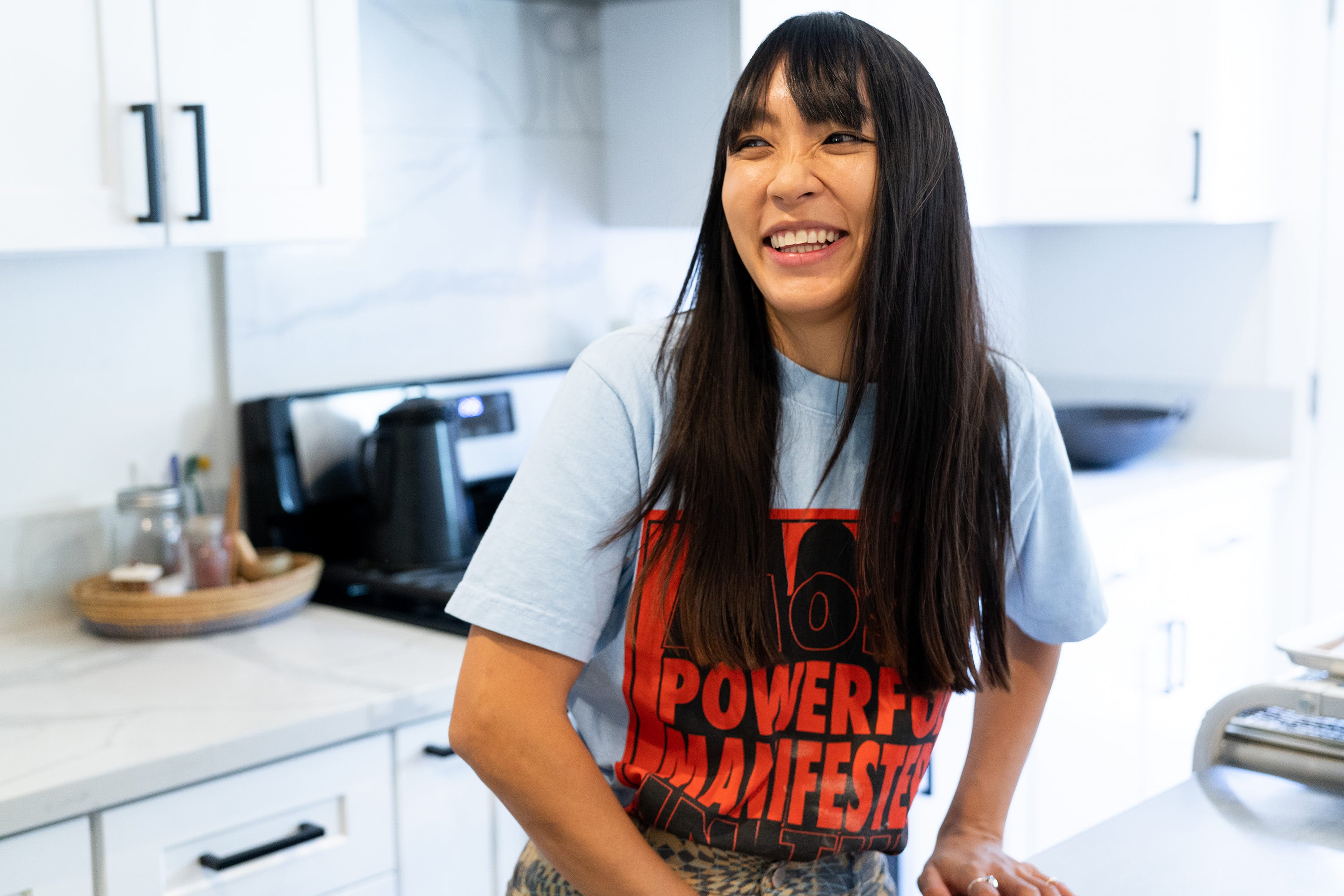 Chef Sandy Truong An Tran Ho smiling in her kitchen