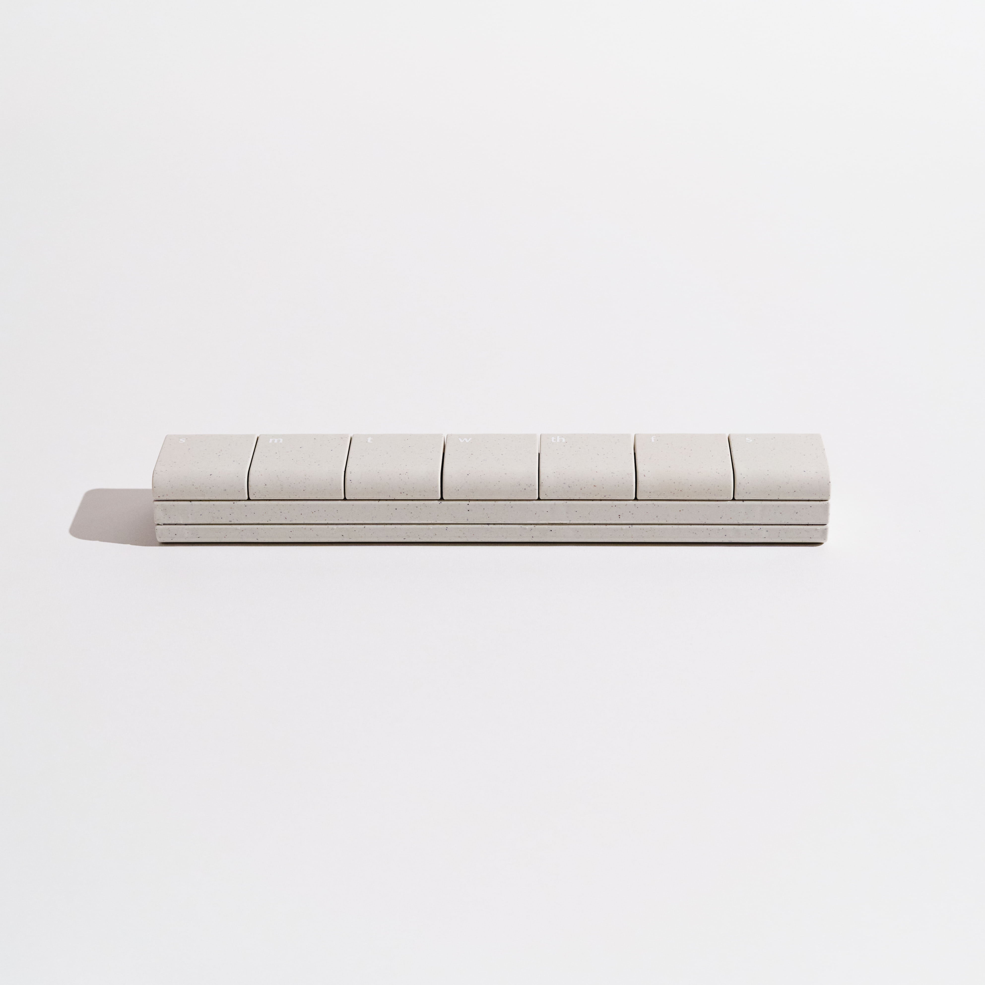 Wide shot of the AndAgain 7-Day Pill Case, a sleek and minimalist supplement organizer for home wellness.