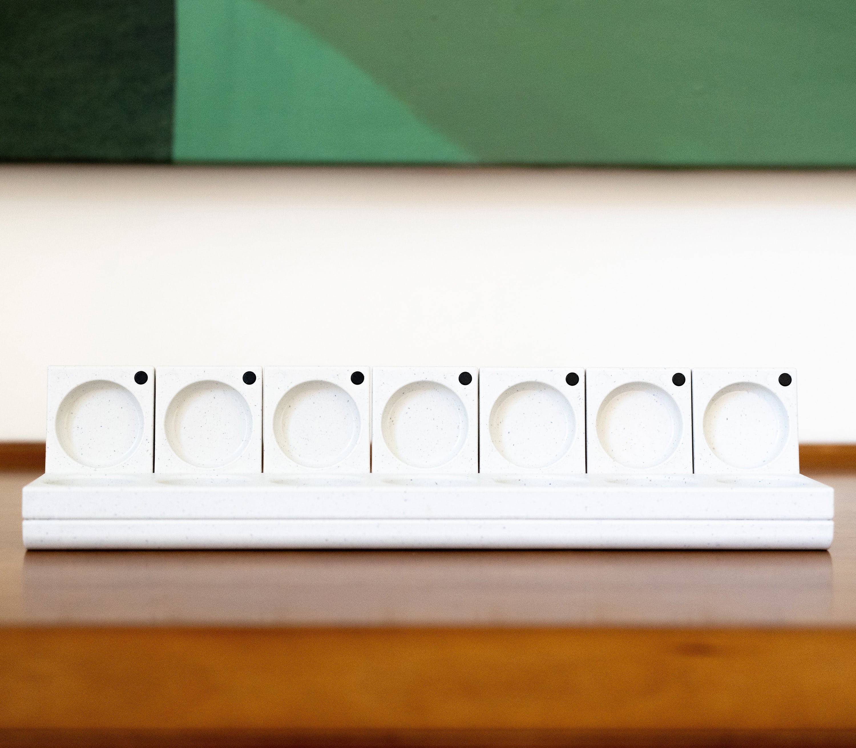 AndAgain 7-day pill case with lids open on a table.