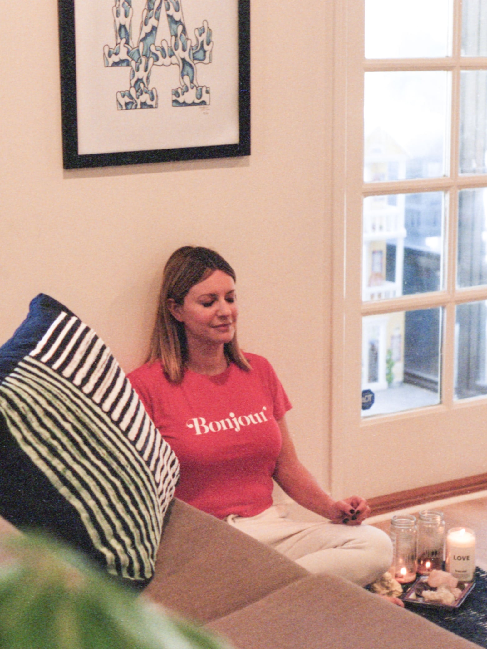 Celebrity makeup artist Jamie Greenberg sitting on the ground meditating