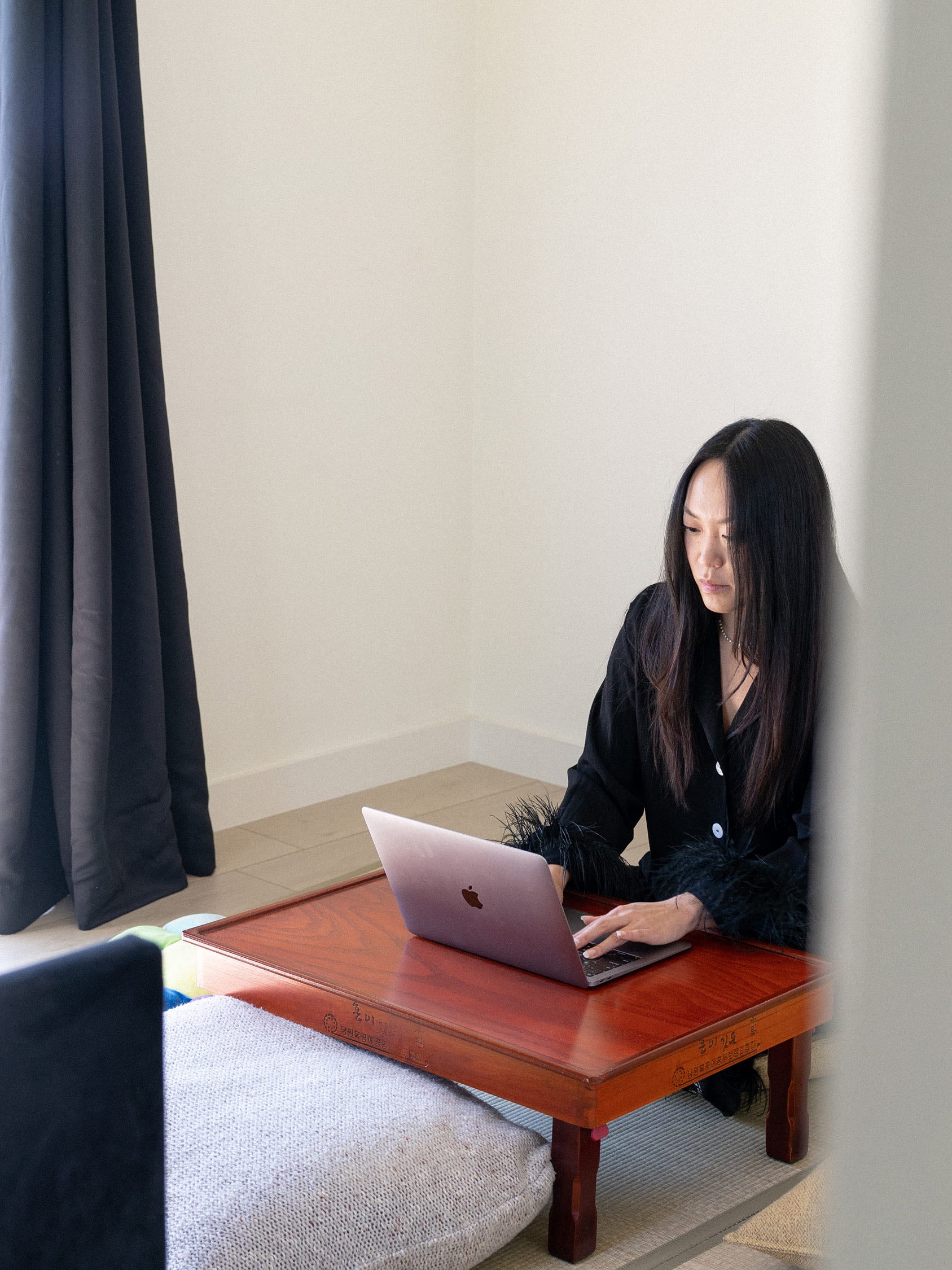 The publicist and founder of SixTen PR, Jen Woodward, working on her laptop.