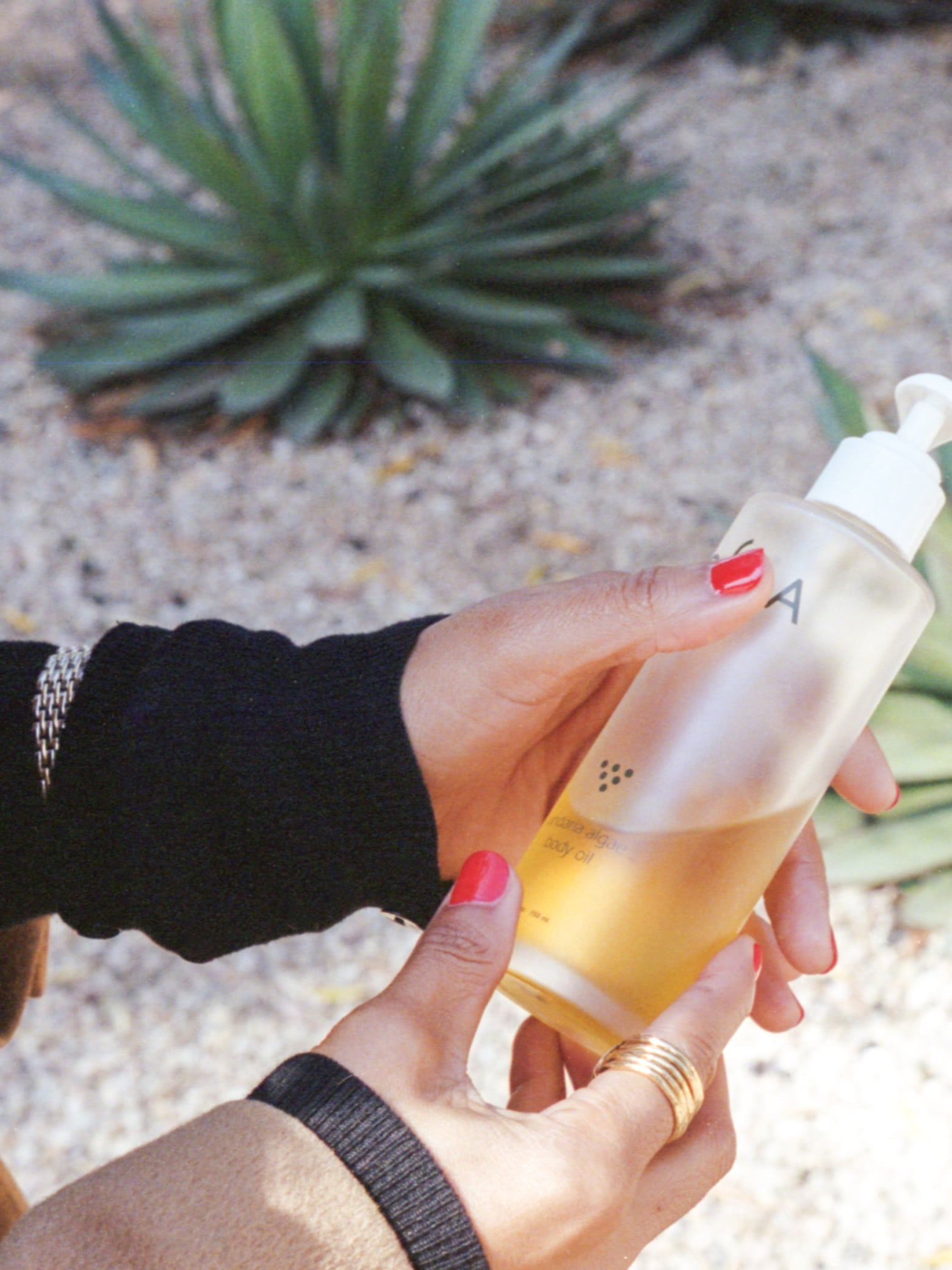 Maxine Goynes holding a bottle of body oil